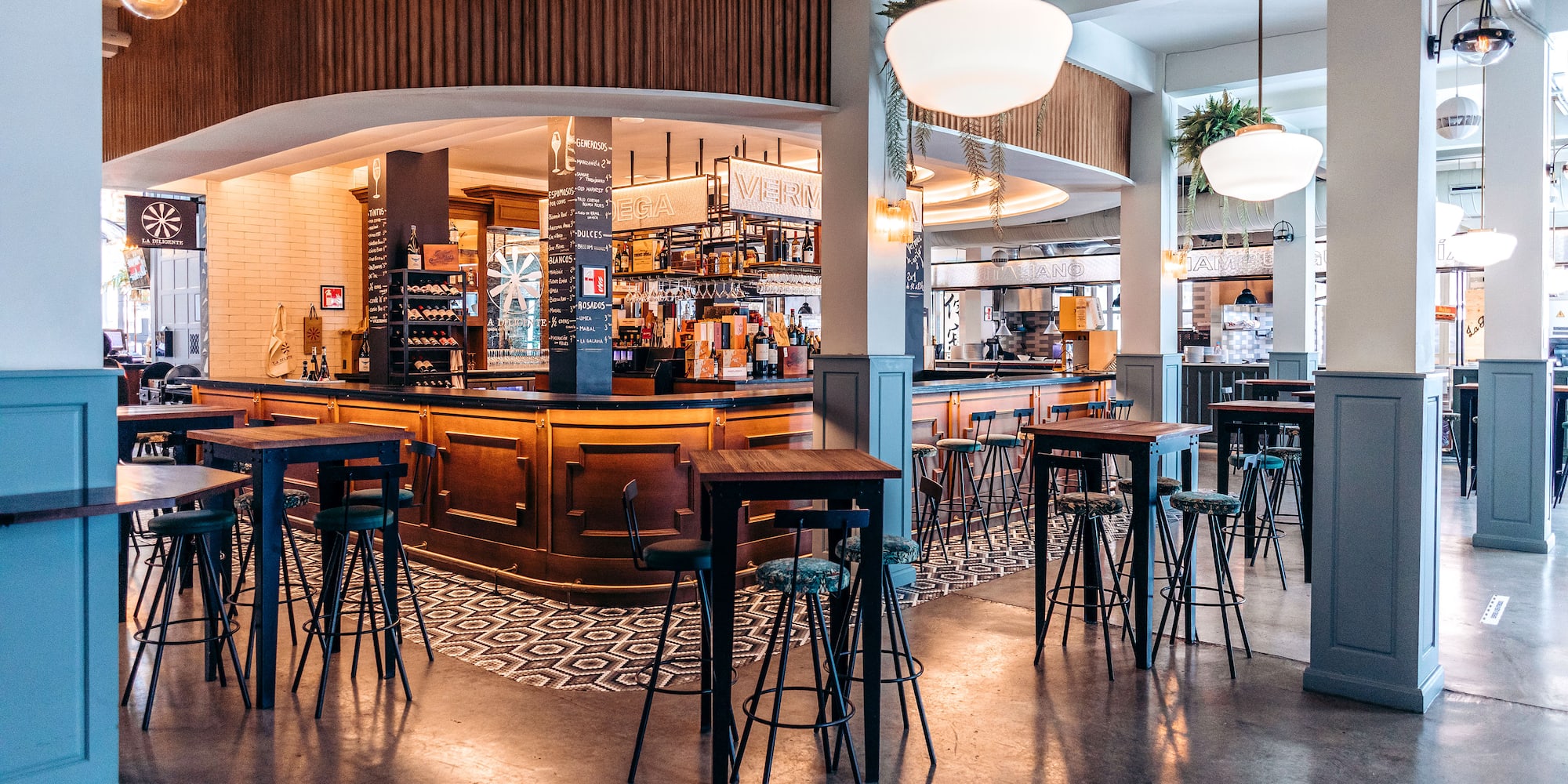 a bar with tables and chairs in a room