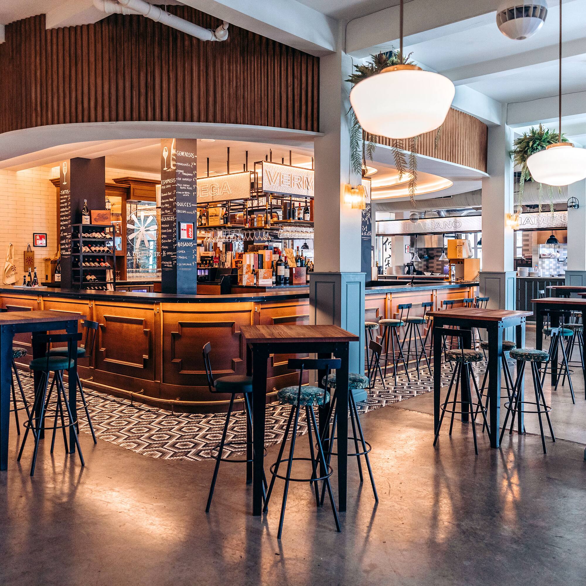 a bar with tables and chairs in a room