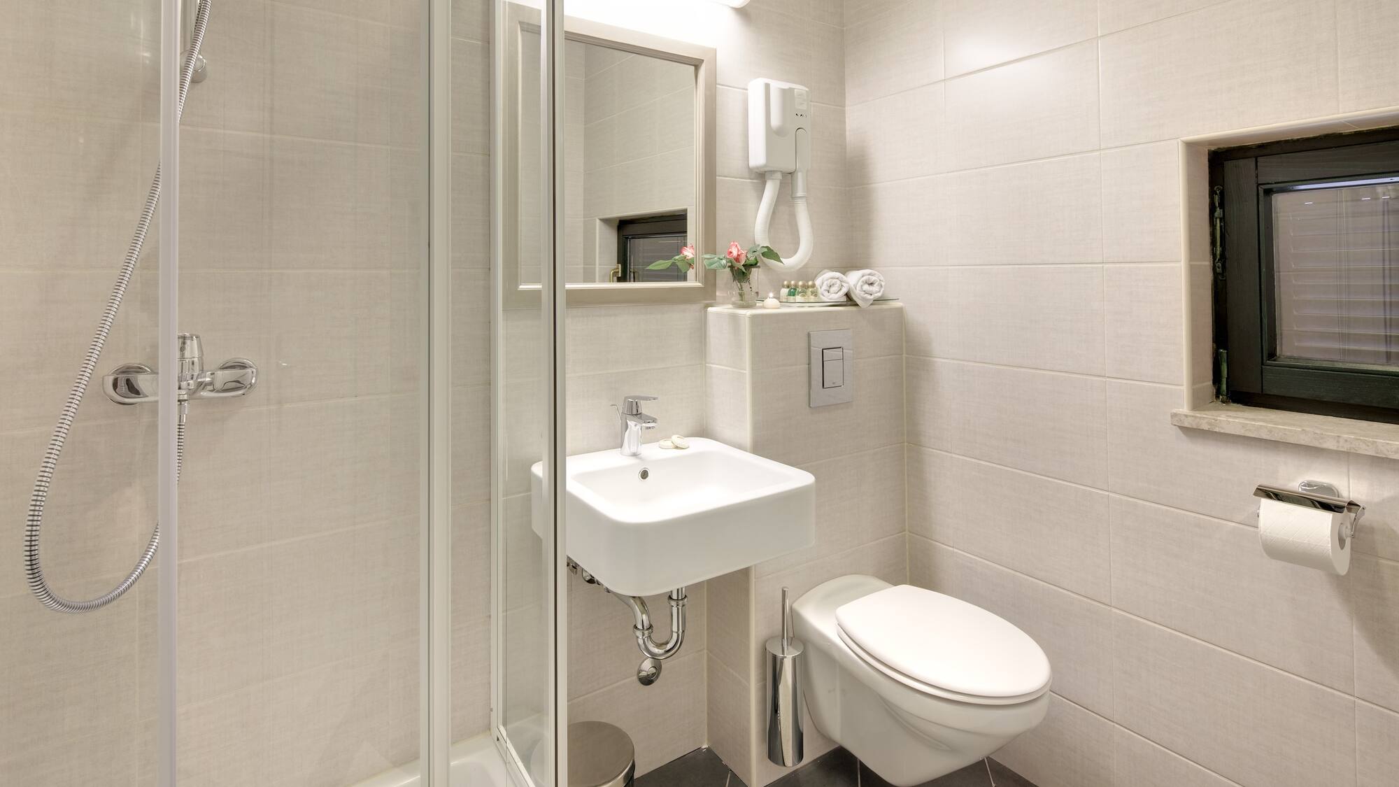 a bathroom with a shower and sink