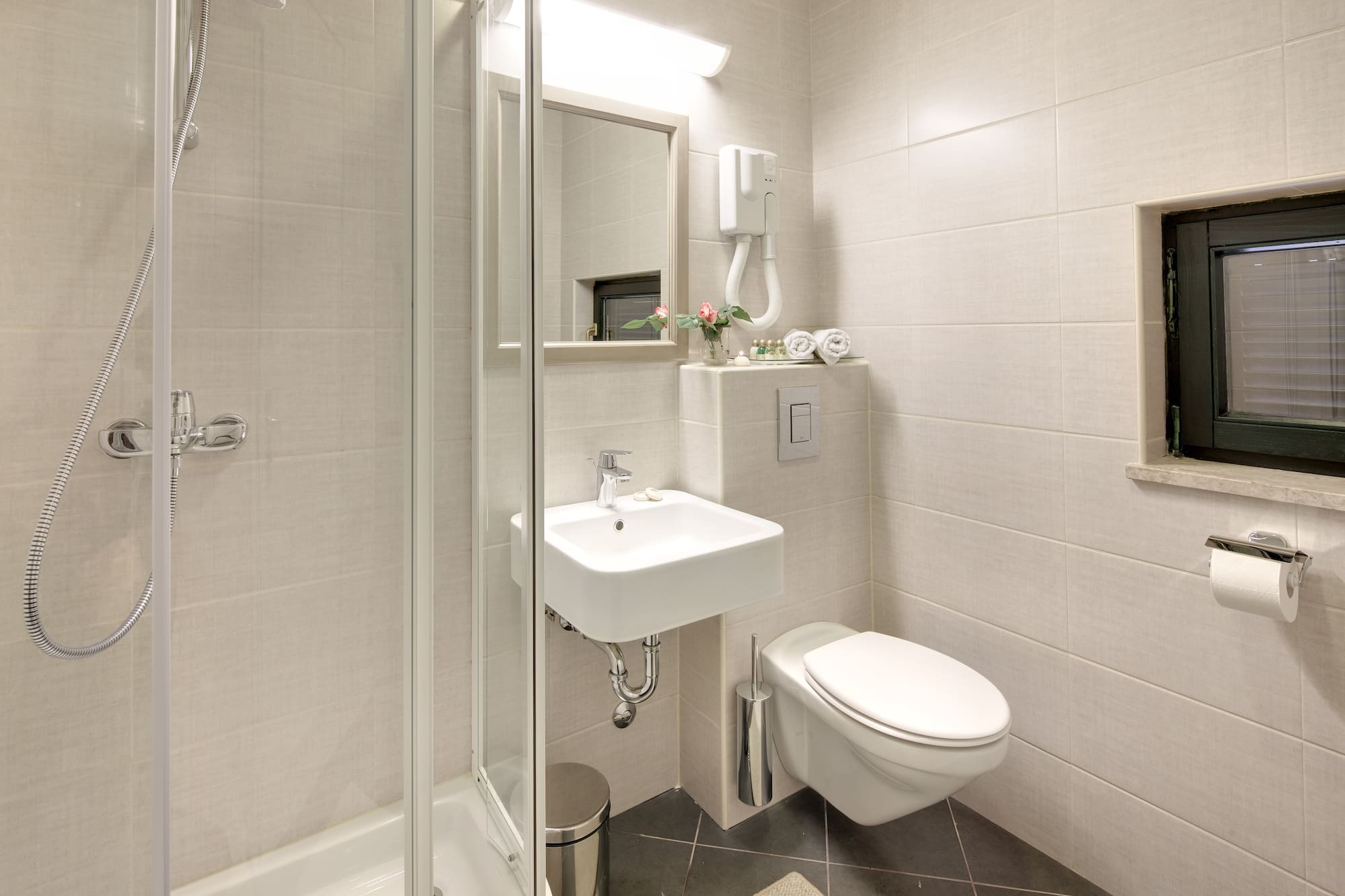 a bathroom with a shower and sink