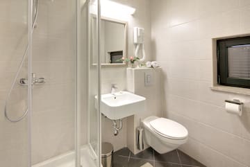 a bathroom with a shower and sink