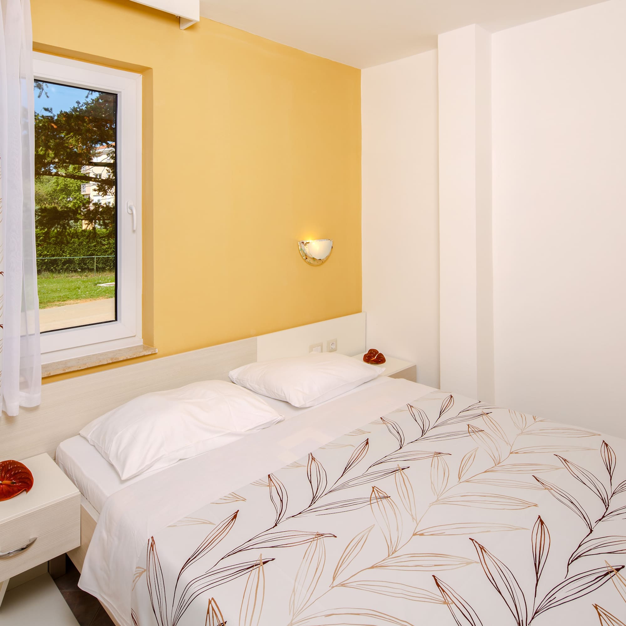 a bed with pillows and a window