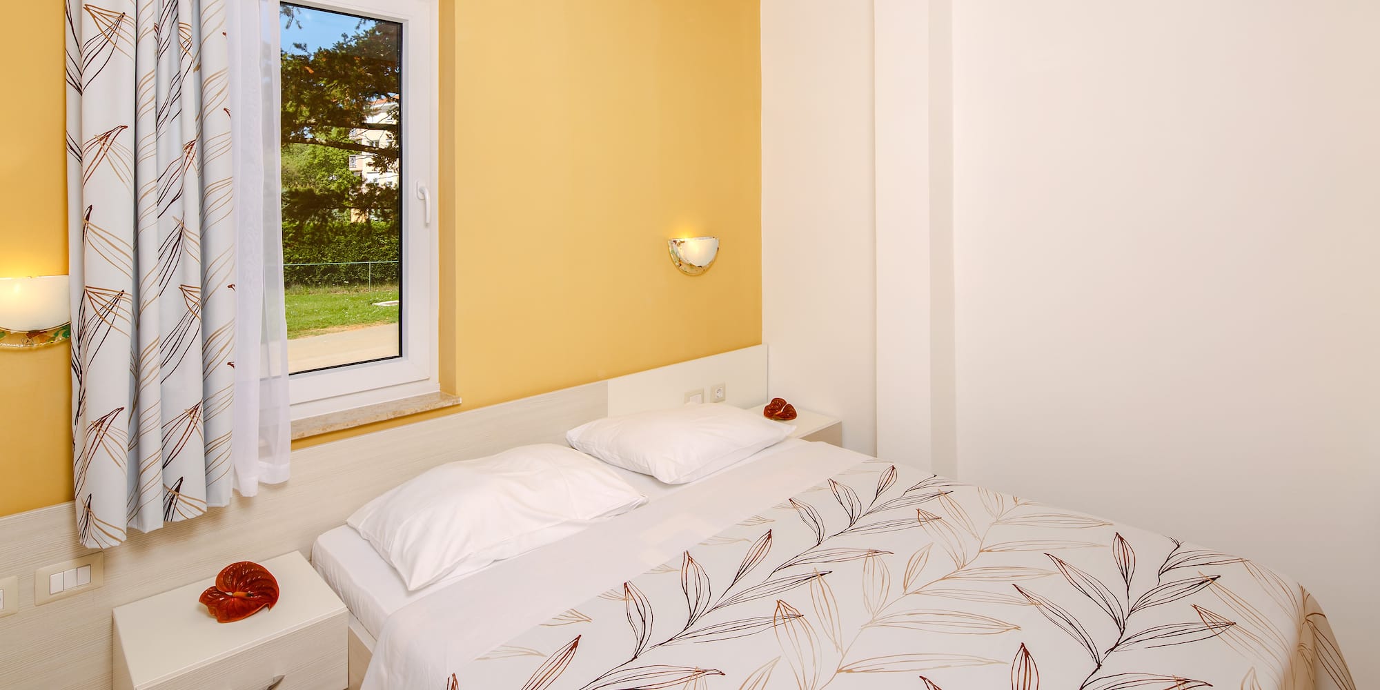 a bed with pillows and a window