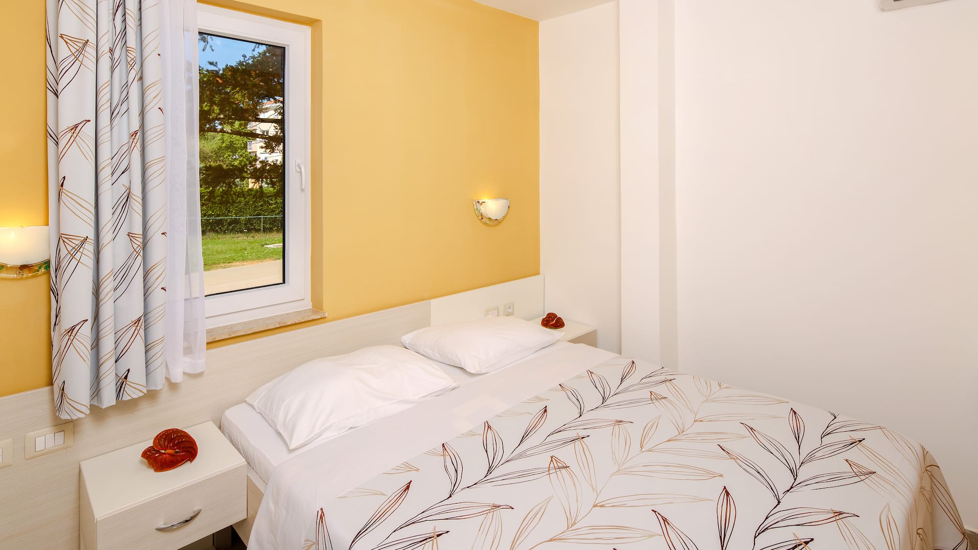 a bed with pillows and a window
