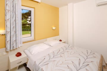 a bed with pillows and a window