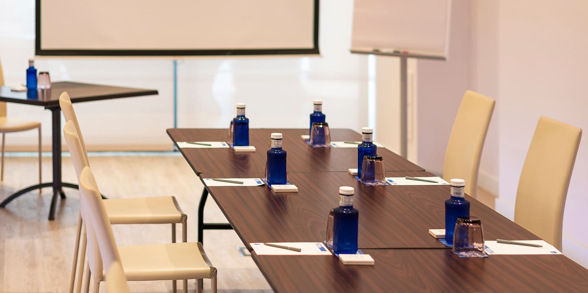 a table with blue bottles and white chairs