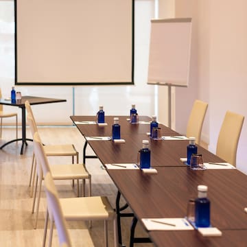 a table with blue bottles and white chairs