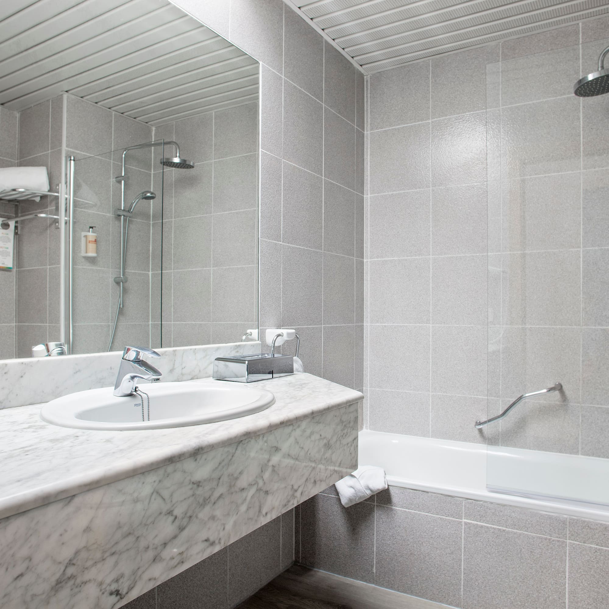 a bathroom with a shower and sink