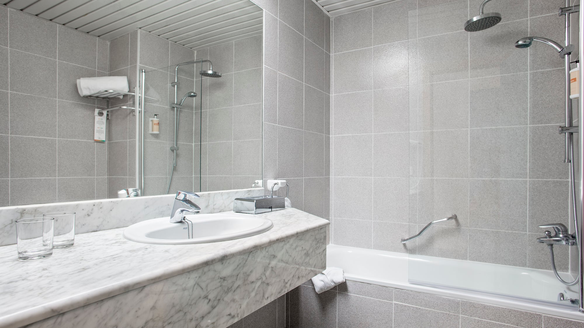 a bathroom with a shower and sink