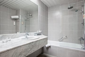 a bathroom with a shower and sink