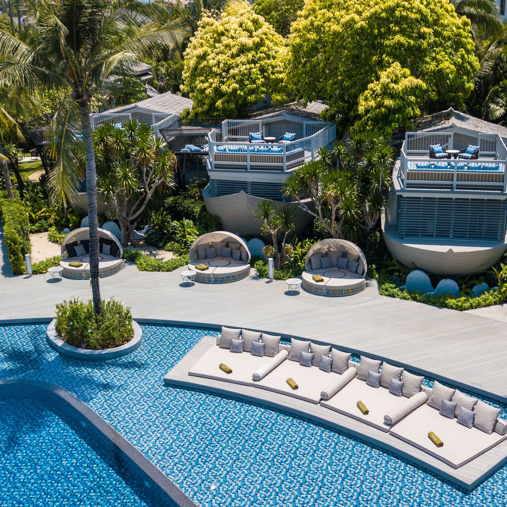 a pool with lounge chairs and trees