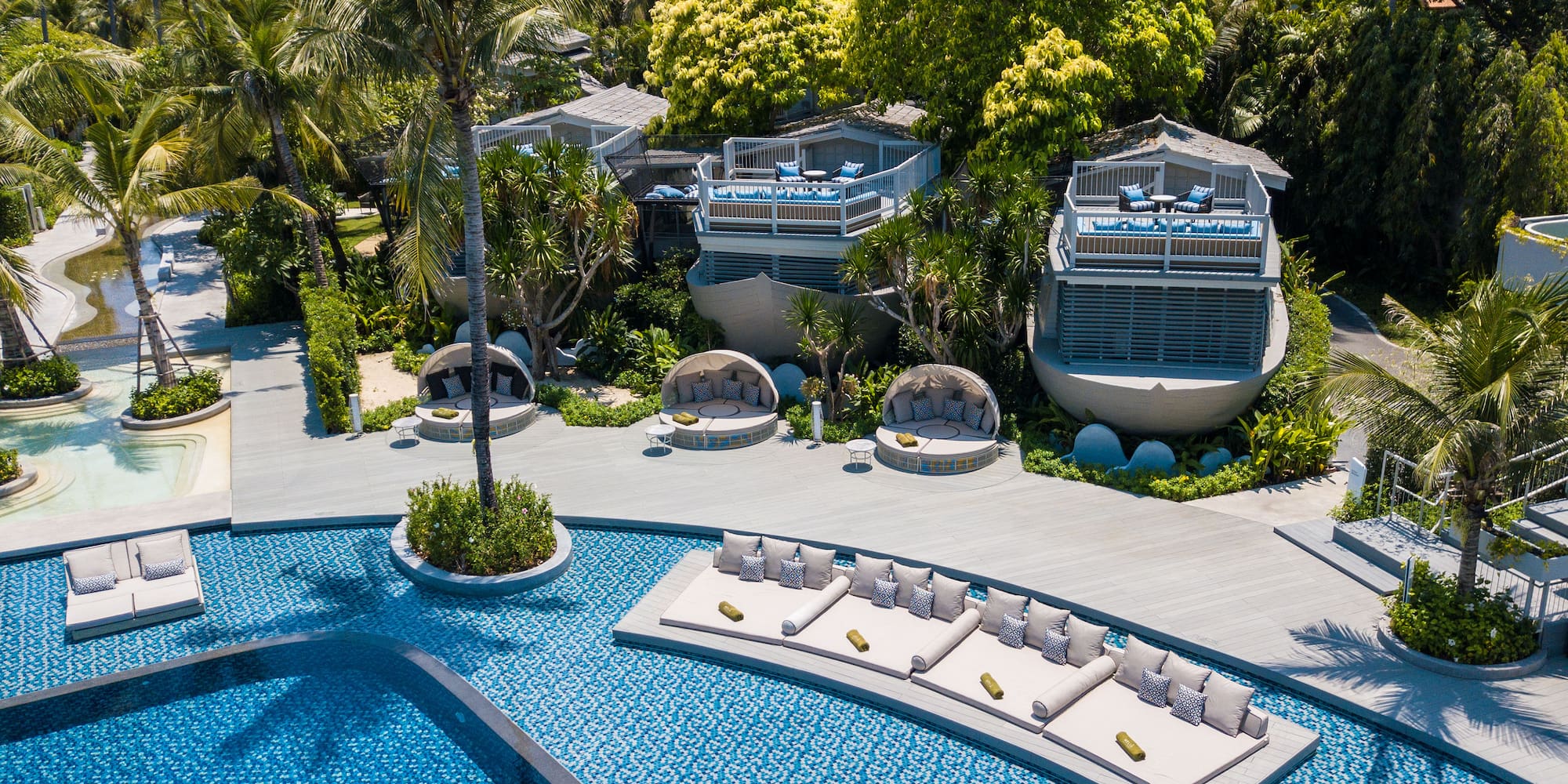 a pool with lounge chairs and trees