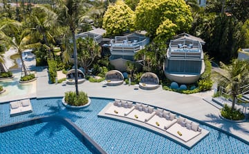 a pool with lounge chairs and trees