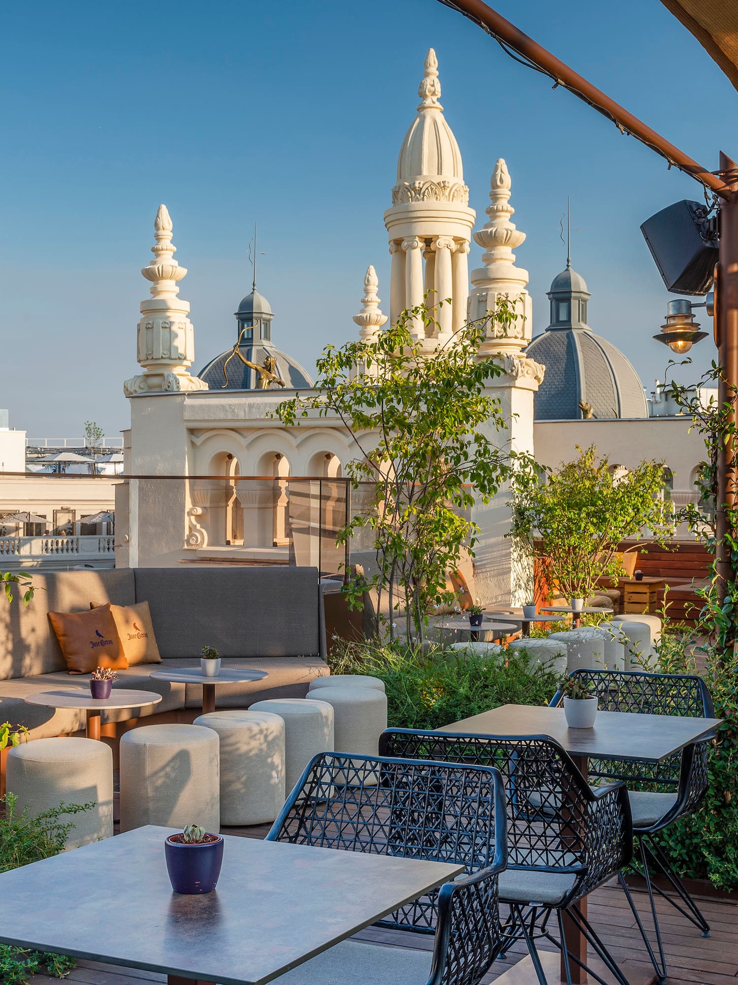 a patio with tables and chairs on a rooftop