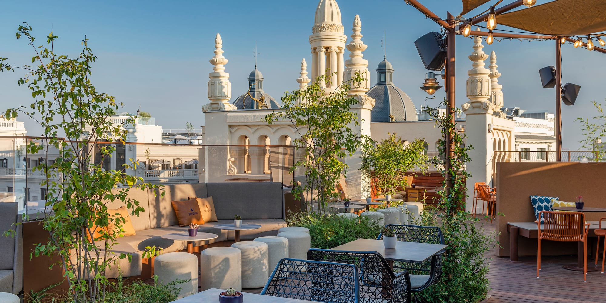 a patio with tables and chairs on a rooftop