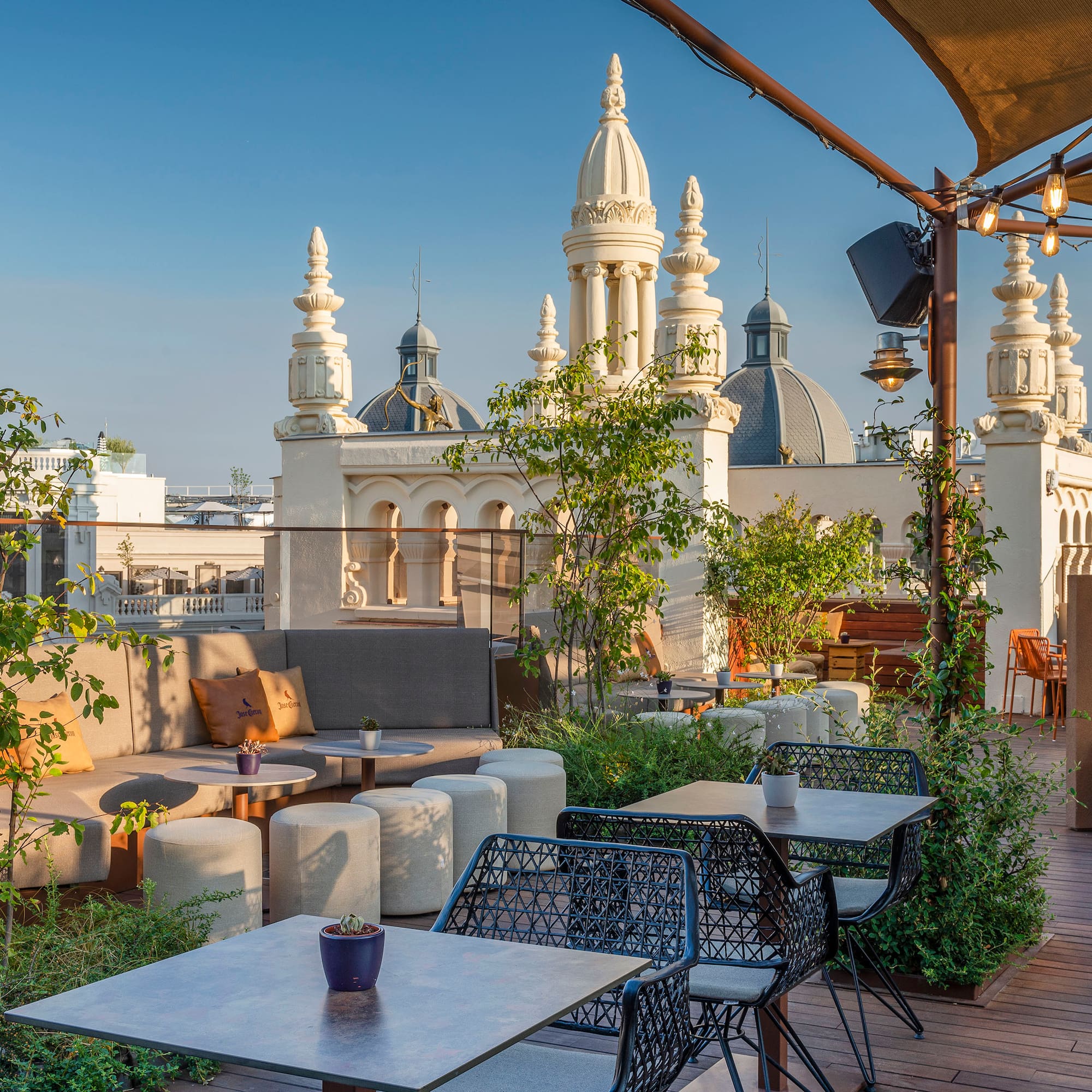 a patio with tables and chairs on a rooftop