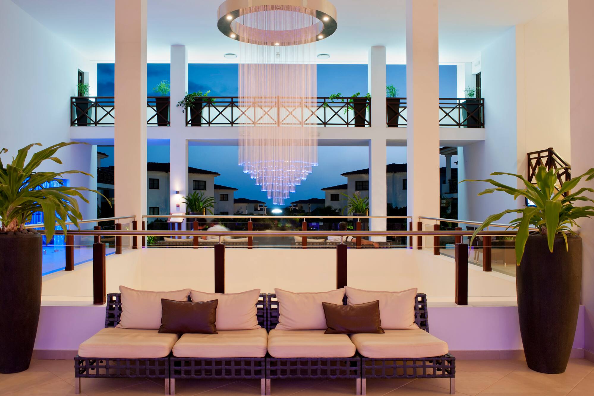 a room with a chandelier and couches