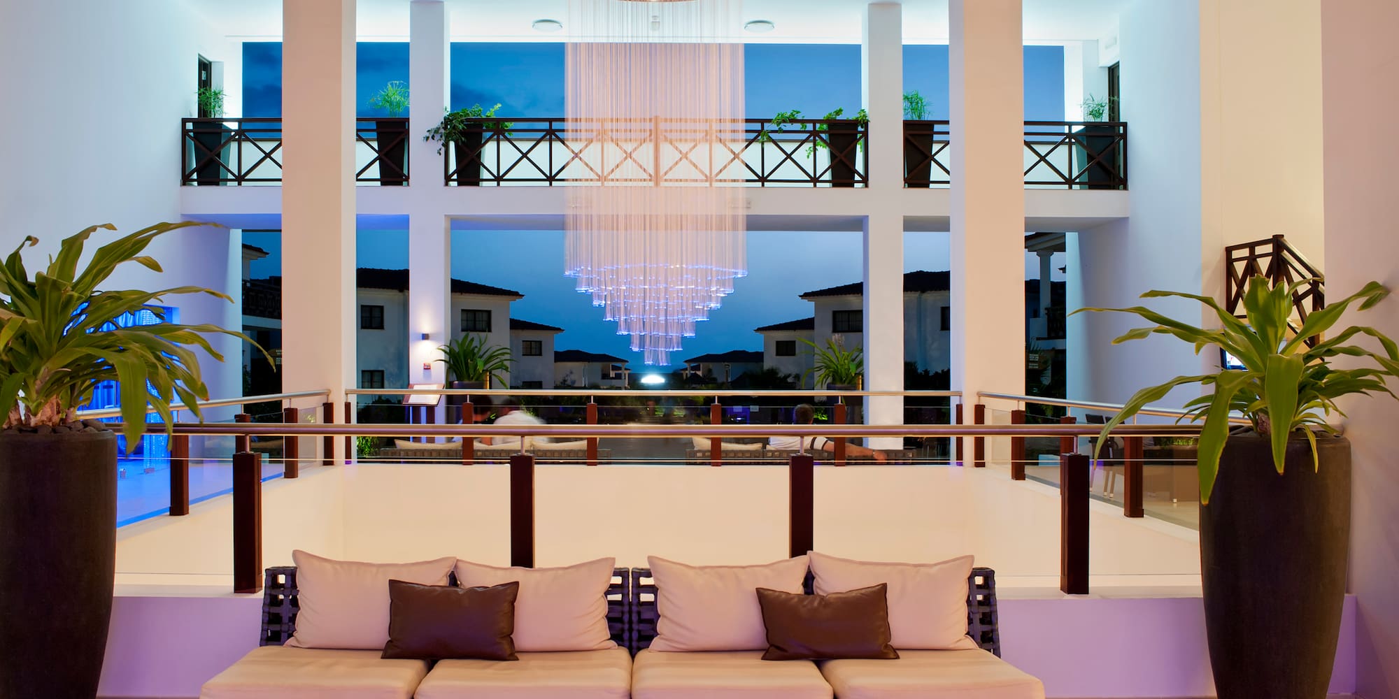 a room with a chandelier and couches