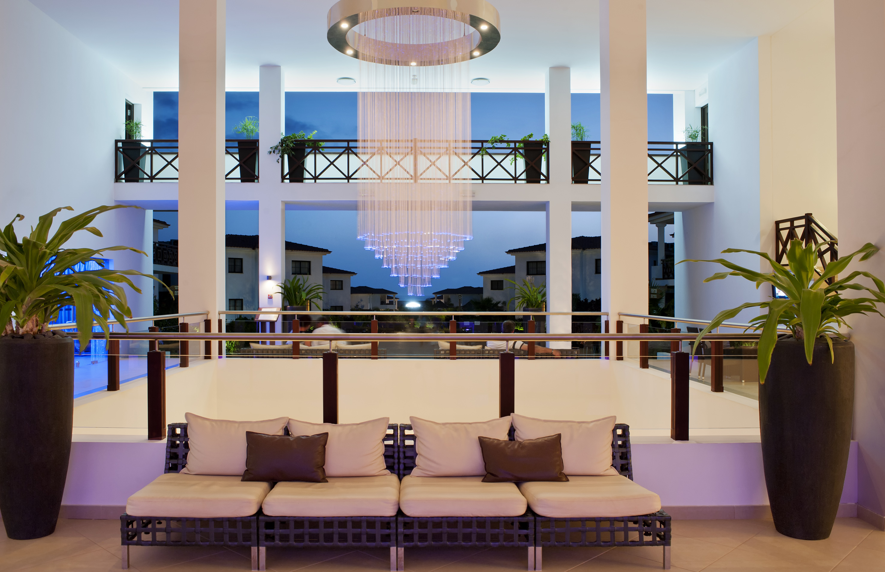 a room with a chandelier and couches