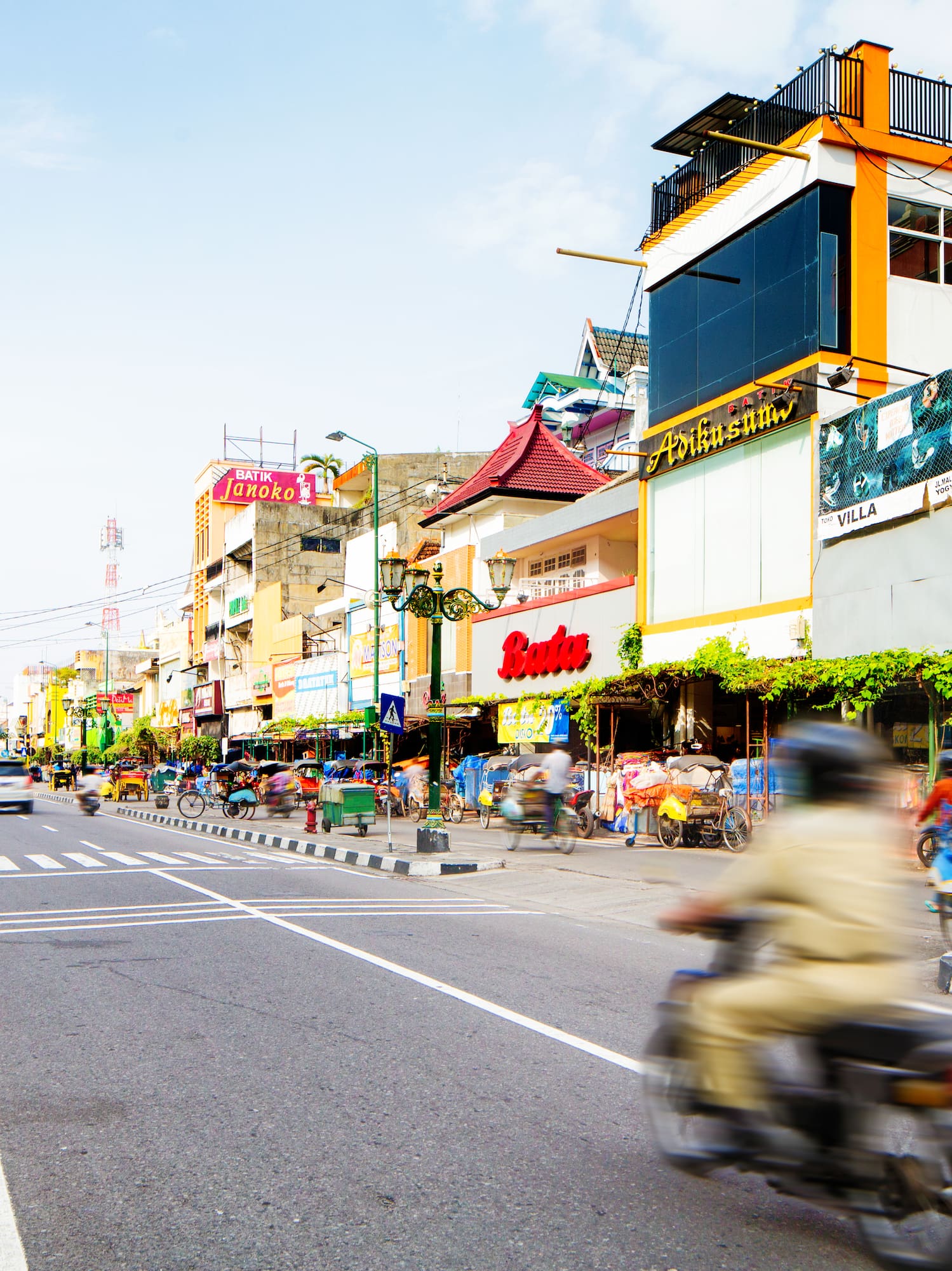 a street with a person on a motorcycle