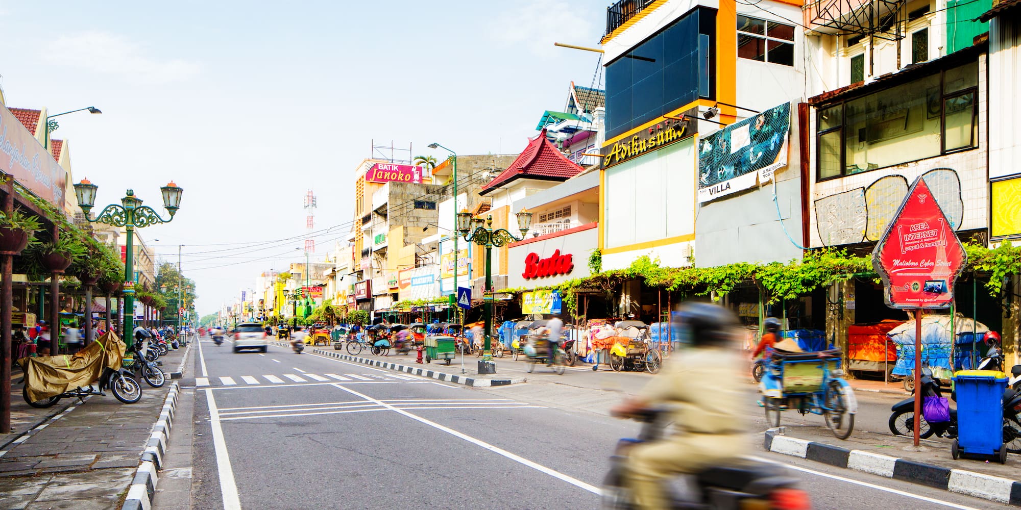 a street with a person on a motorcycle