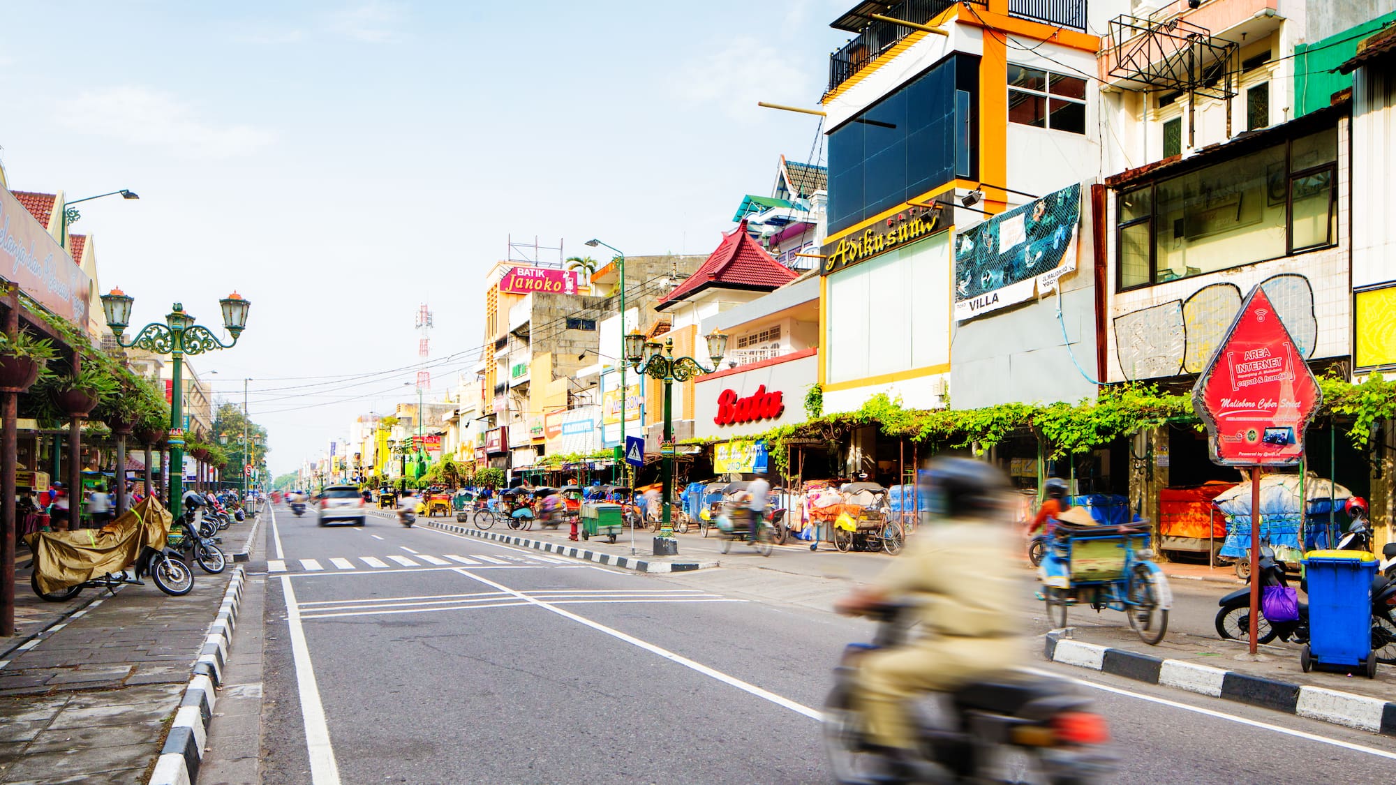 a street with a person on a motorcycle