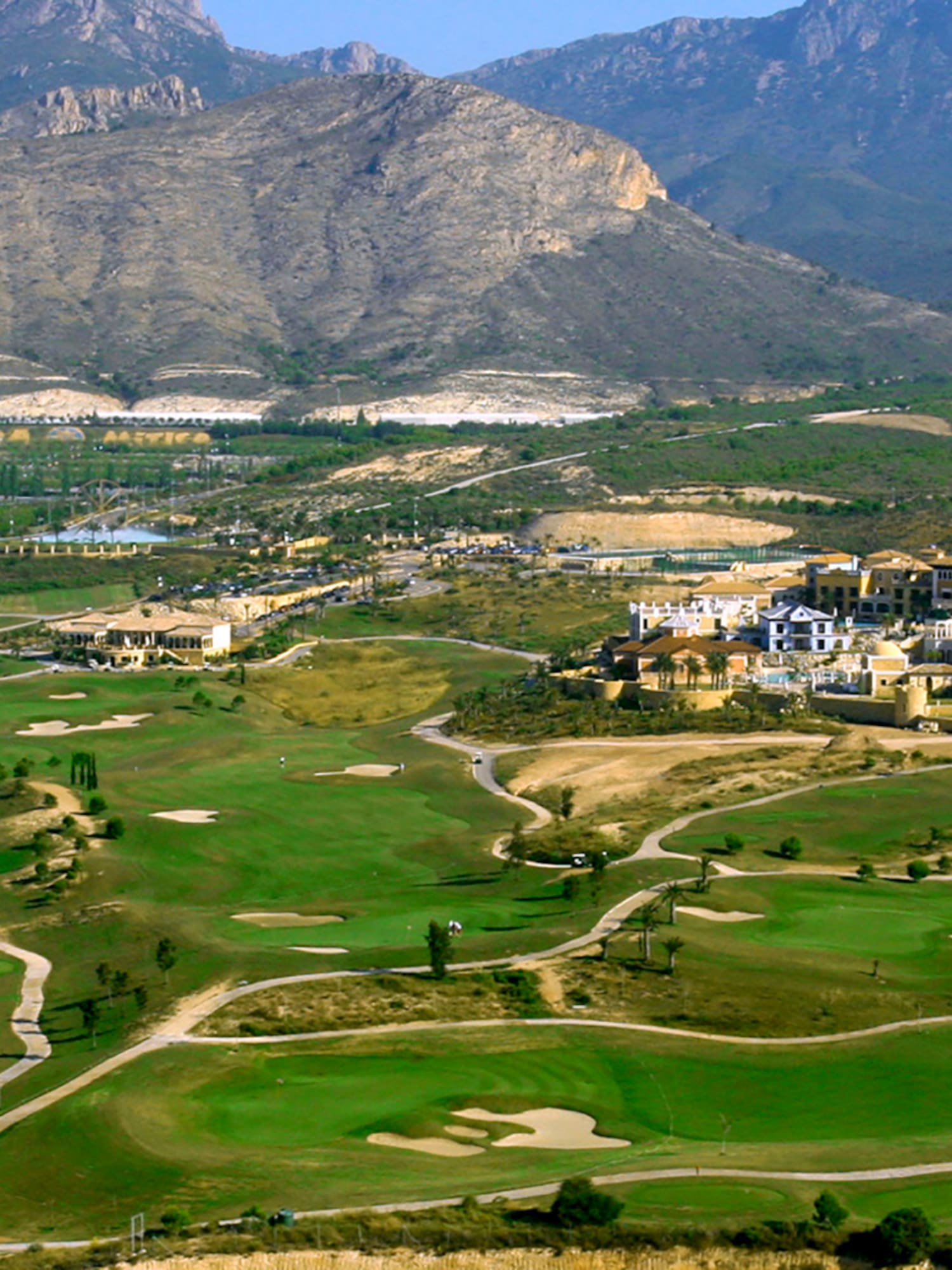 a golf course with a large building in the background