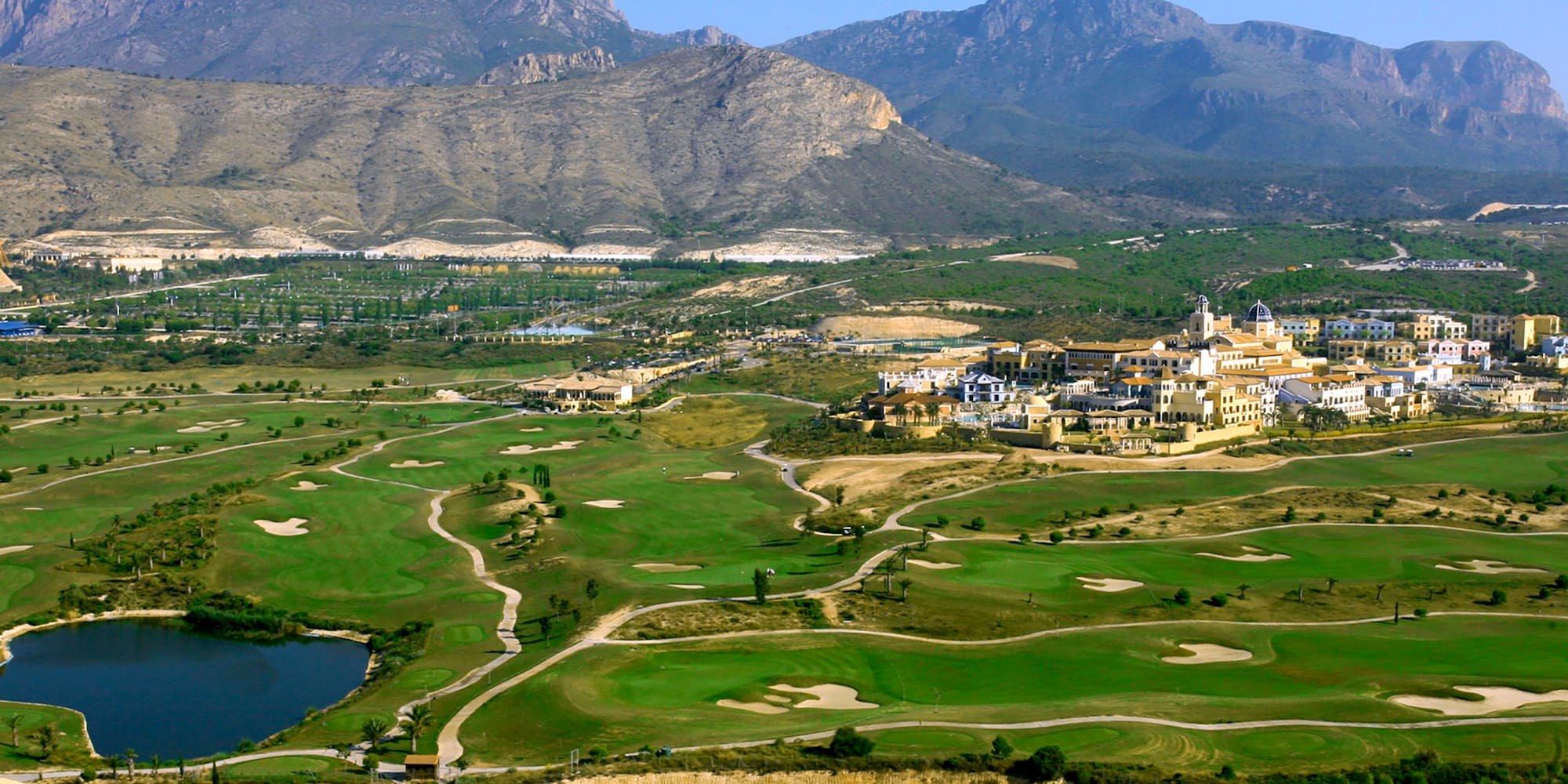 a golf course with a large building in the background