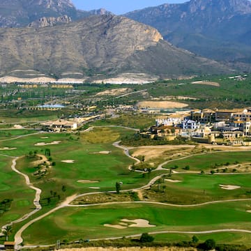 a golf course with a large building in the background