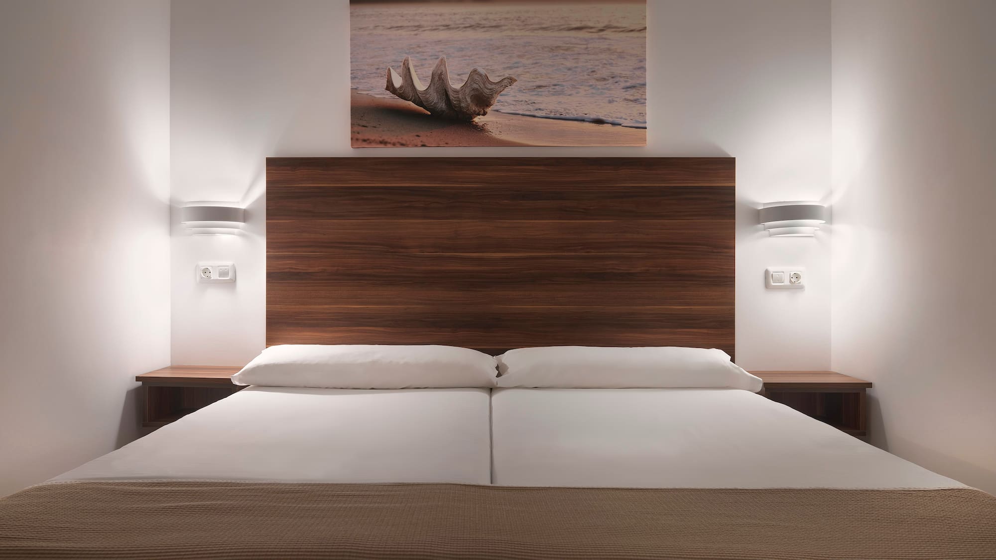 a bed with a wood headboard and a picture above it