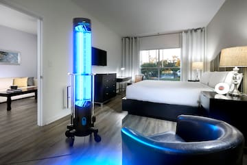 a room with a bed and a large lamp