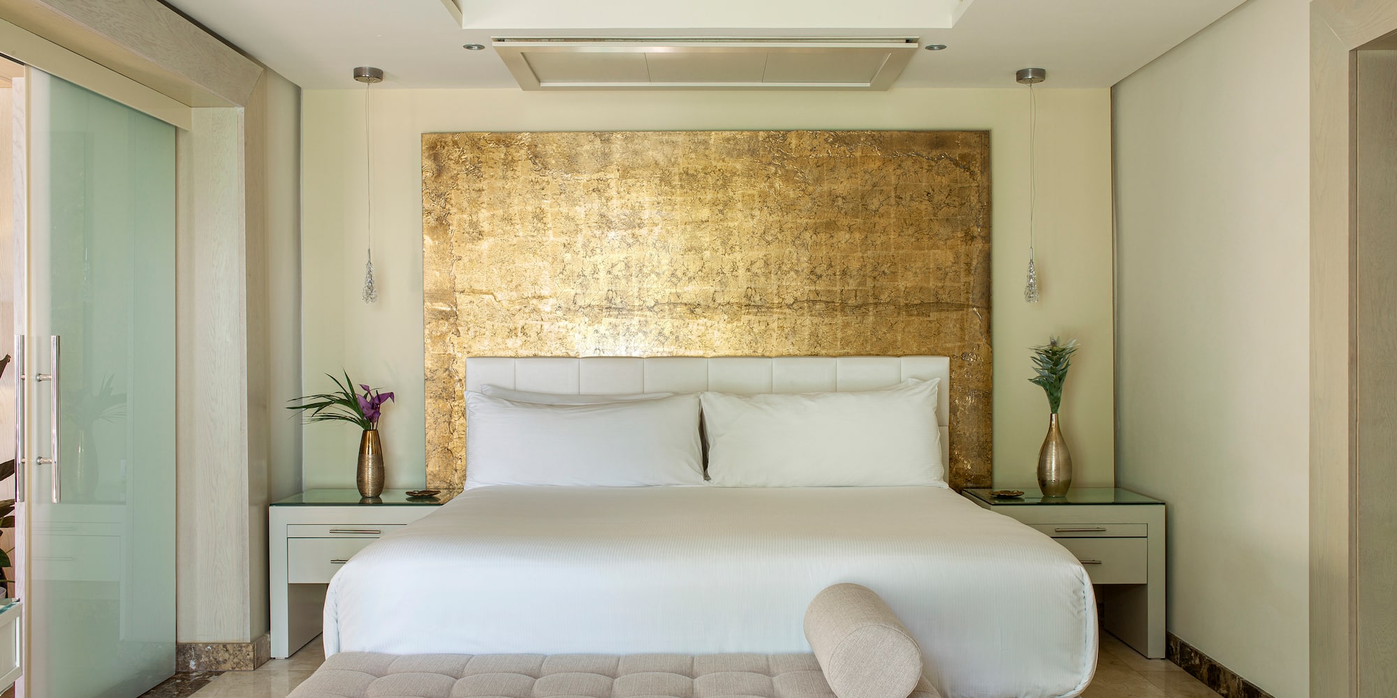 a bed with a bench in a room