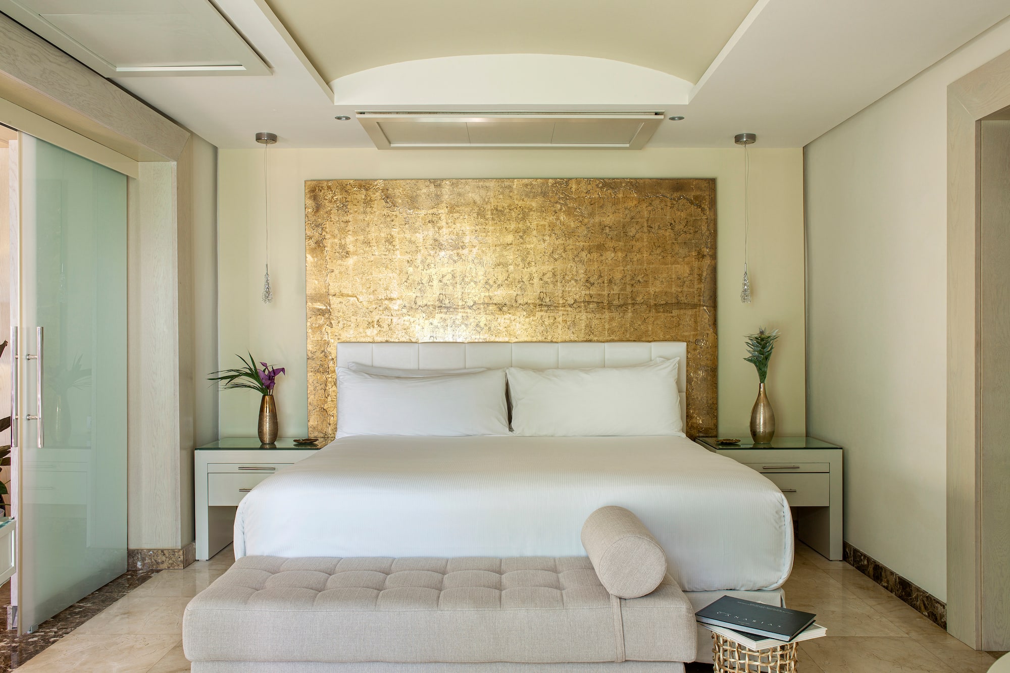 a bed with a bench in a room