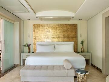 a bed with a bench in a room