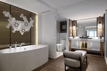 a bathroom with a tub and a mirror