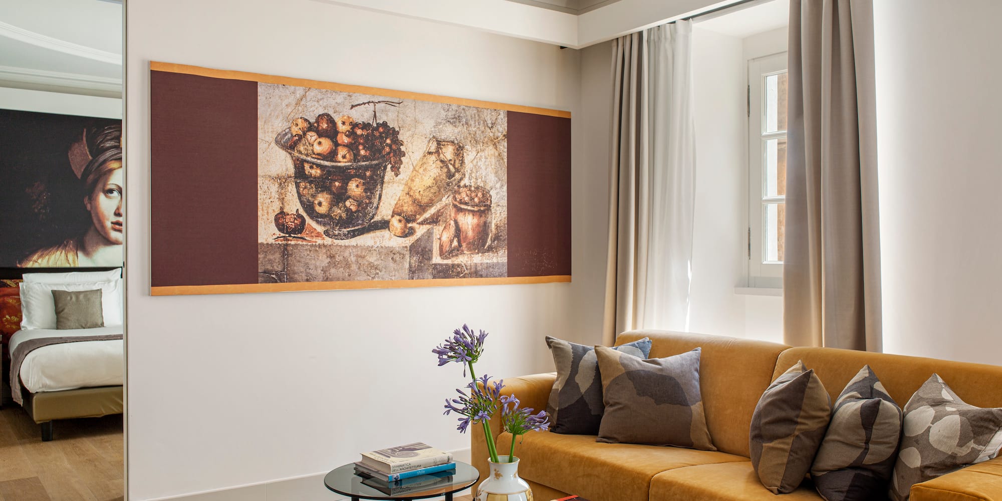 a living room with a couch and a painting on the wall