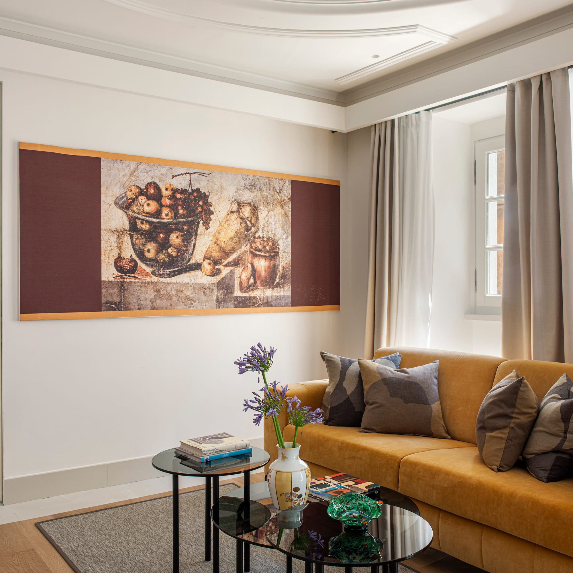 a living room with a couch and a painting on the wall