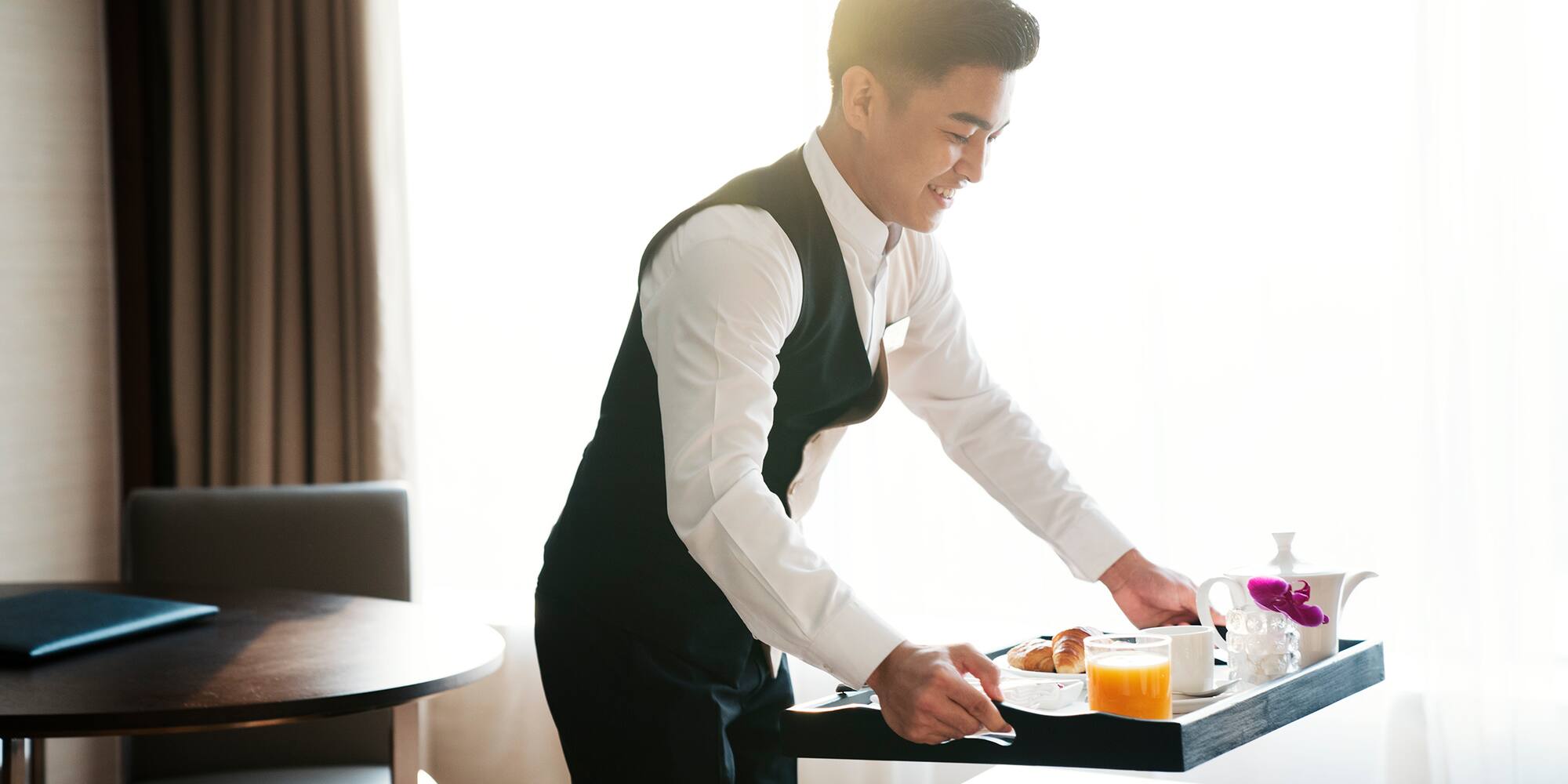 a man holding a tray with food on it