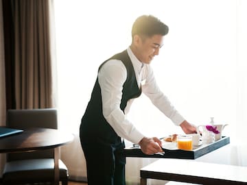 a man holding a tray with food on it