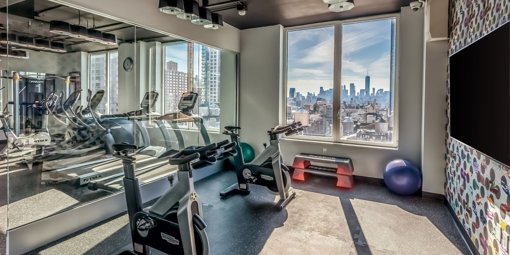 a room with exercise bikes and a large window