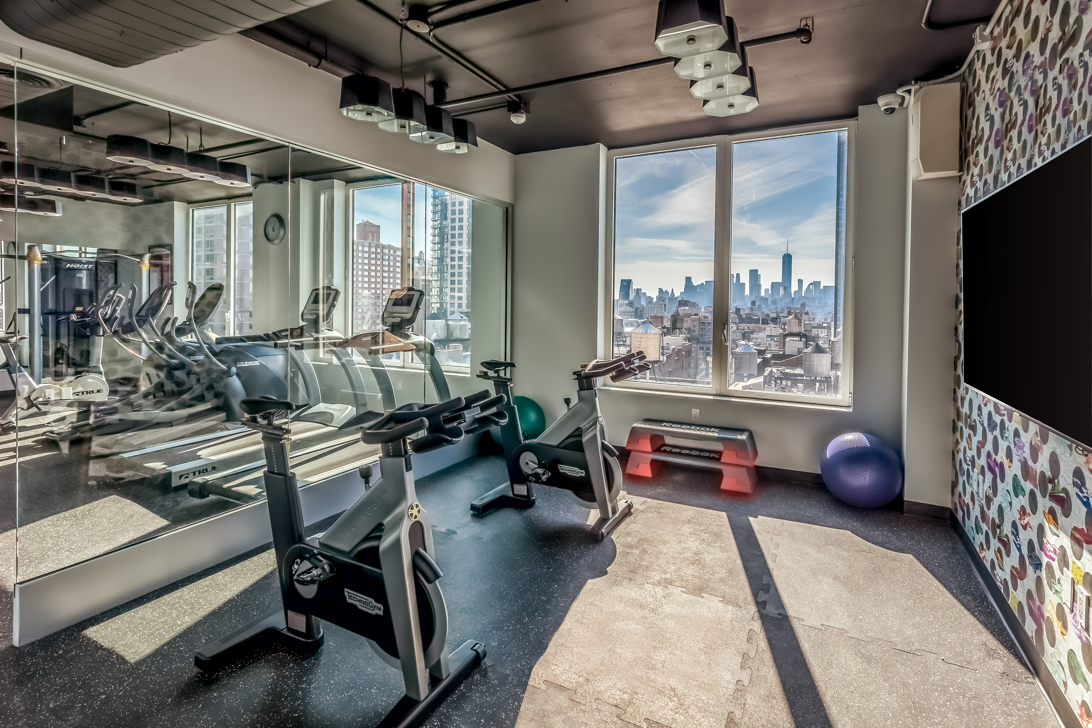 a room with exercise bikes and a large window
