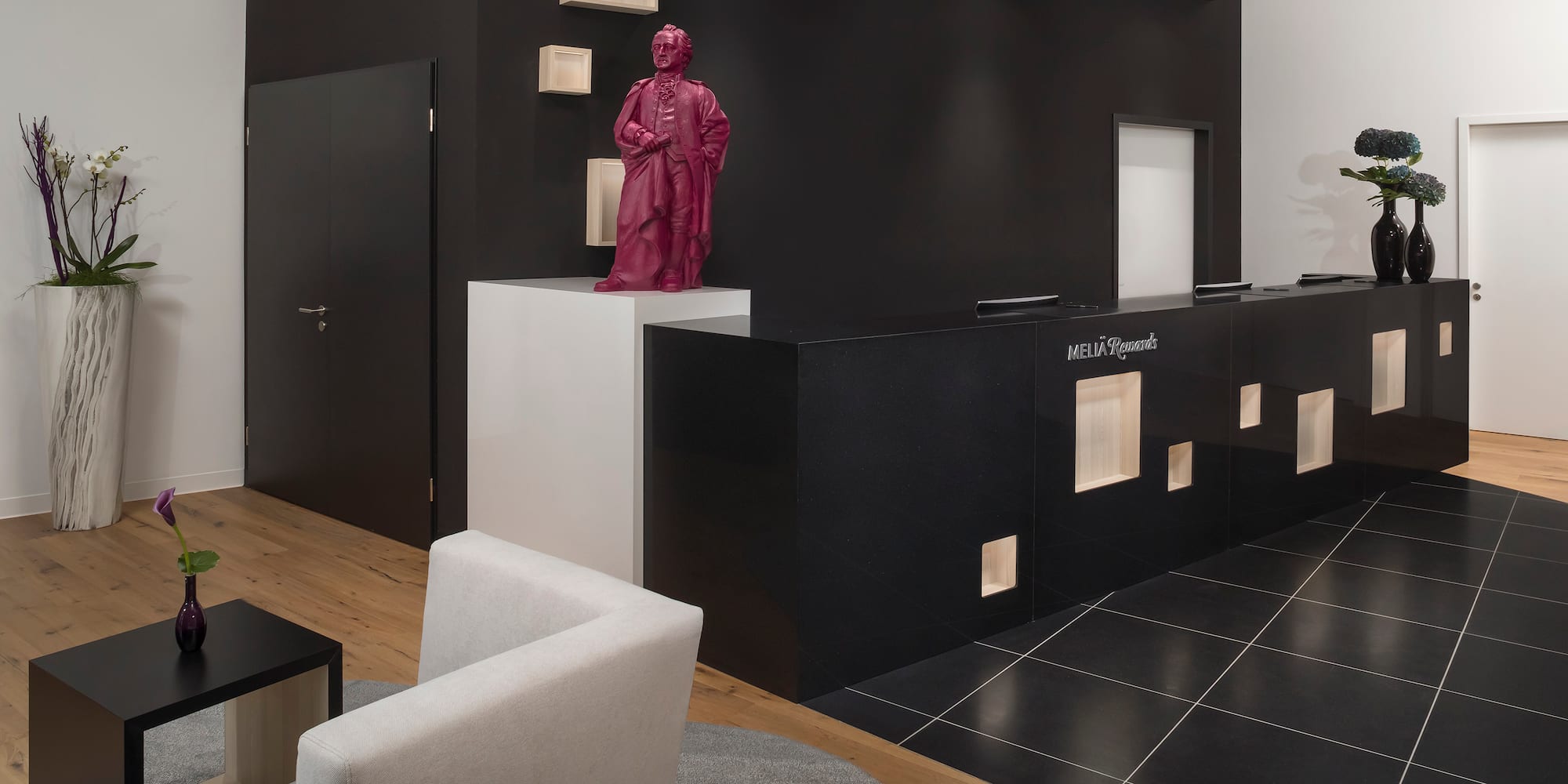 a pink statue on a black and white counter