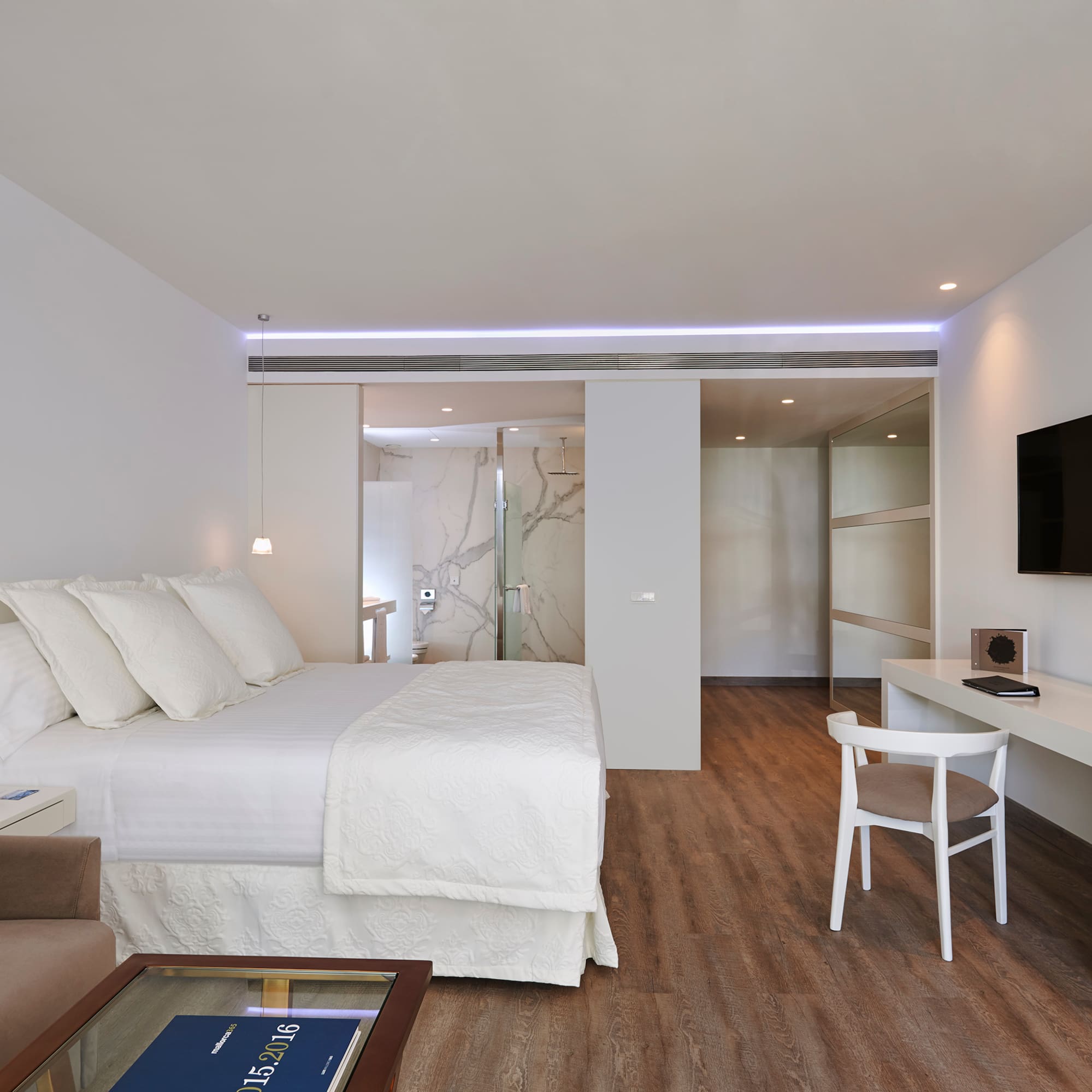 a bedroom with a tv and a bed