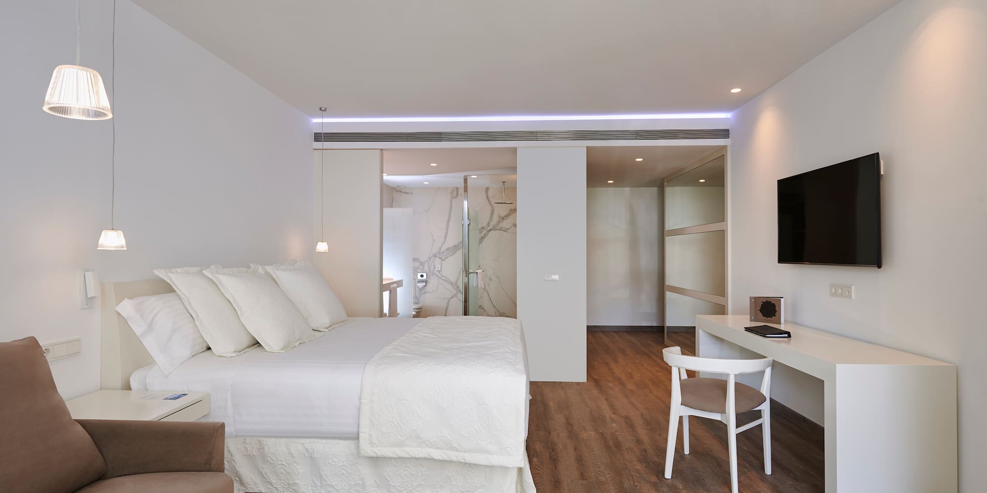 a bedroom with a tv and a bed