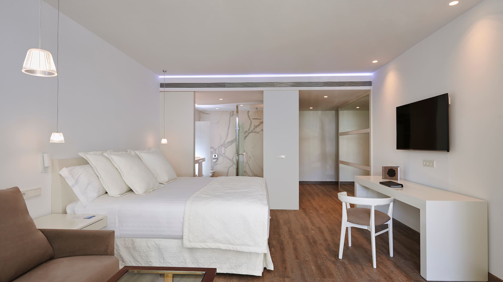 a bedroom with a tv and a bed