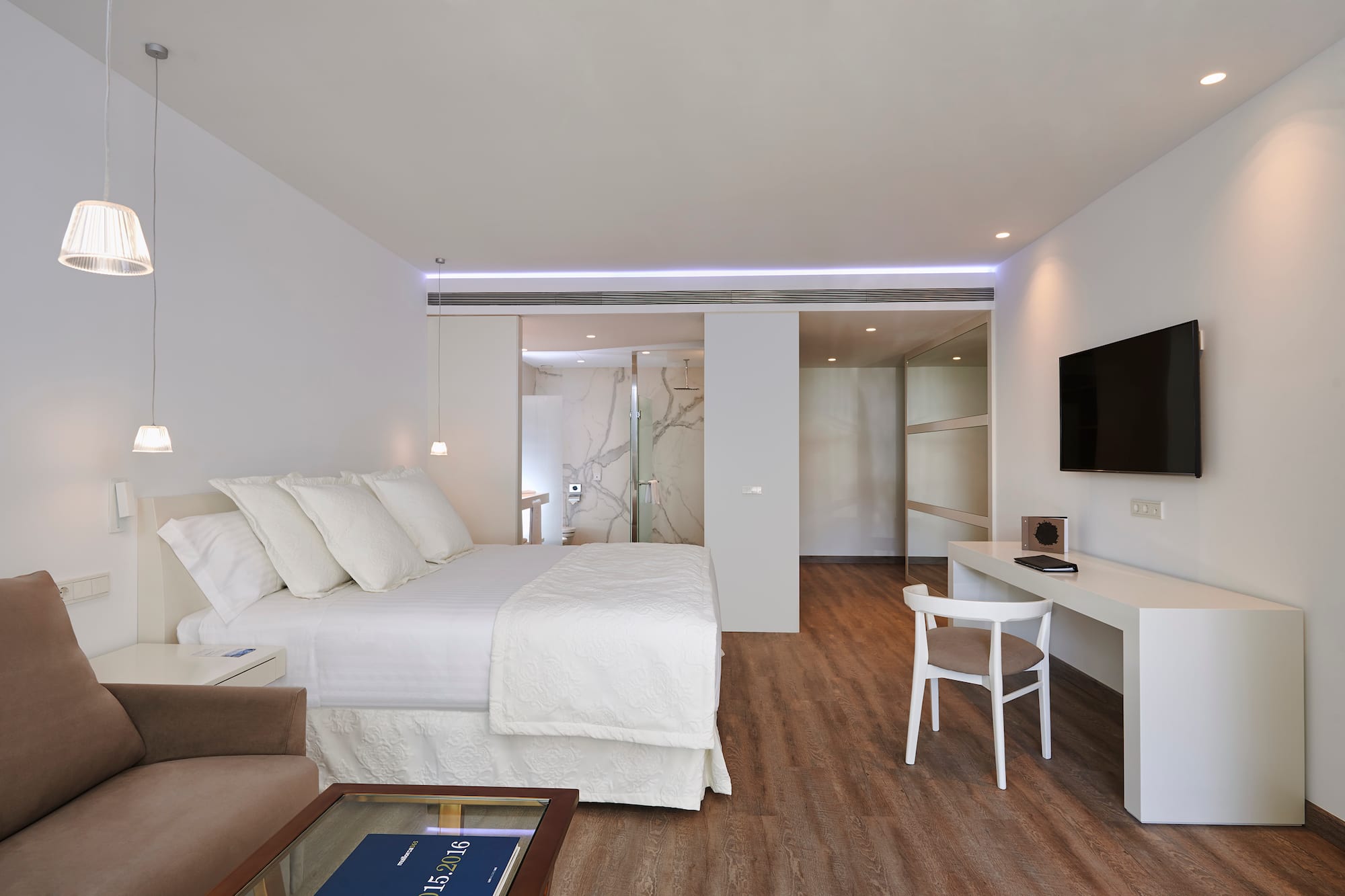 a bedroom with a tv and a bed