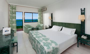 a bedroom with a bed and chairs