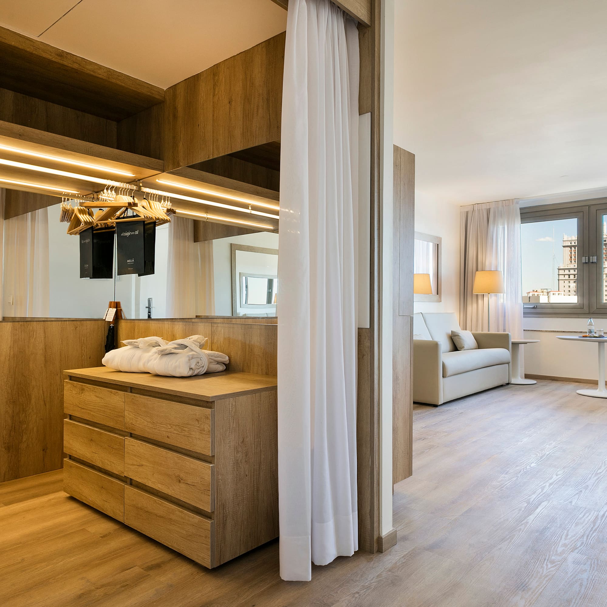 a room with a mirror and a dresser