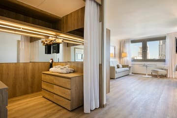 a room with a mirror and a dresser