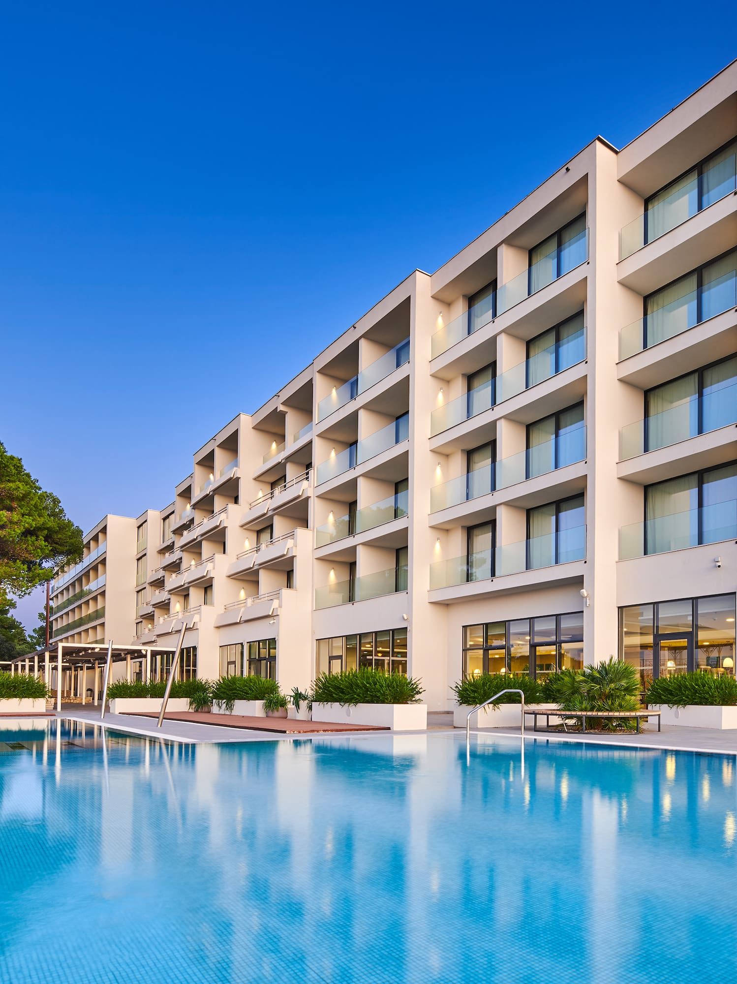 a large building with a pool in front of it